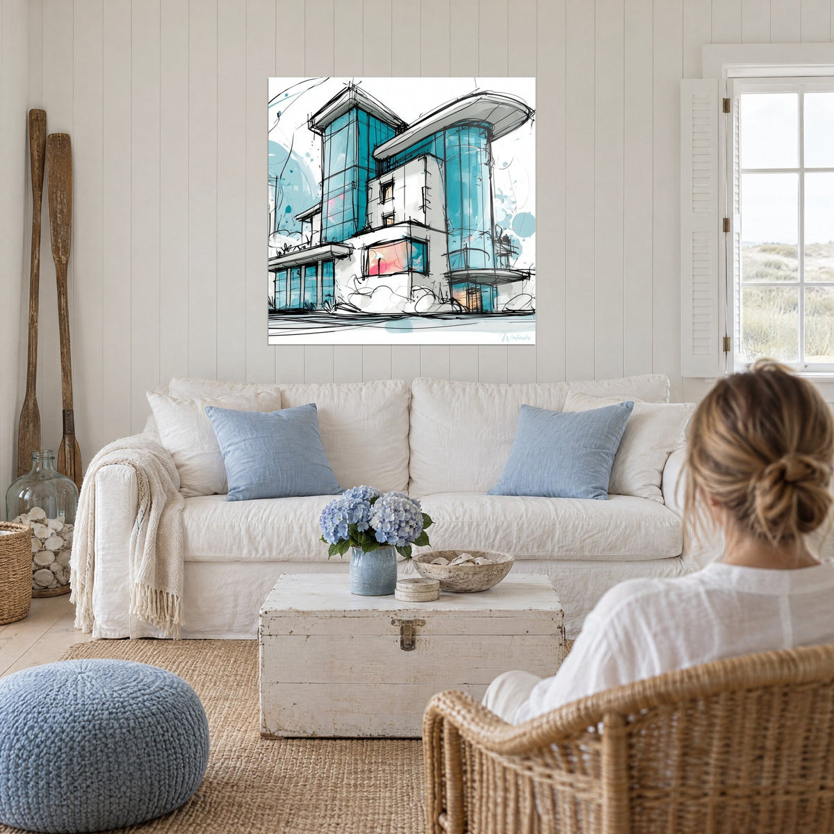 Tableau façade vitrée turquoise aux traits d'encre noire, murs blancs, touches roses, au-dessus d'un canapé dans un salon lumineux