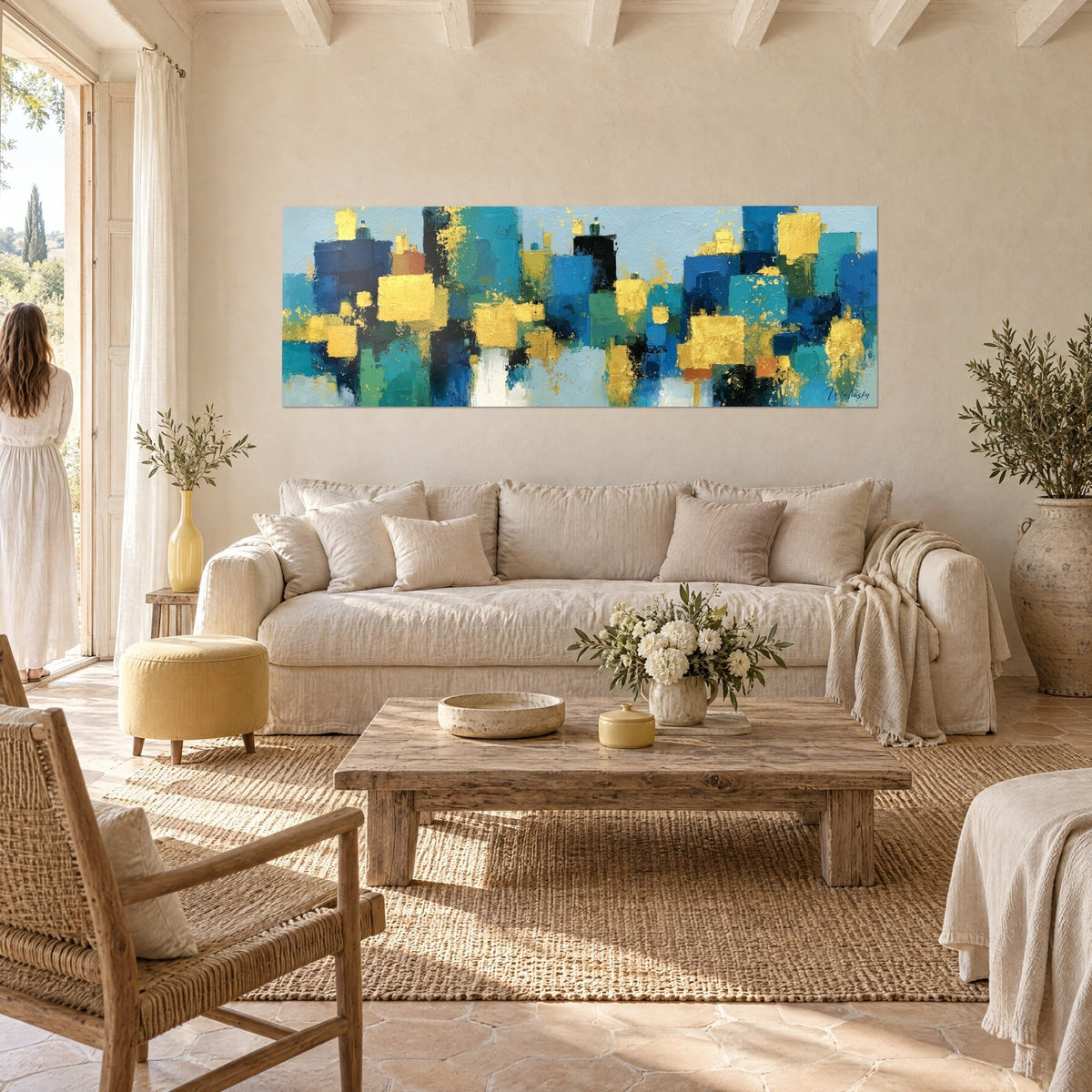 Tableau skyline urbain en blocs bleu marine et turquoise rehaussés de touches d'or, au-dessus d'un canapé dans un salon lumineux