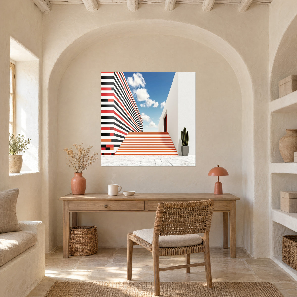 Tableau bâtiment à bandes rouges et noires, cactus vert dans un pot gris, ciel azur, accroché dans un bureau voûté