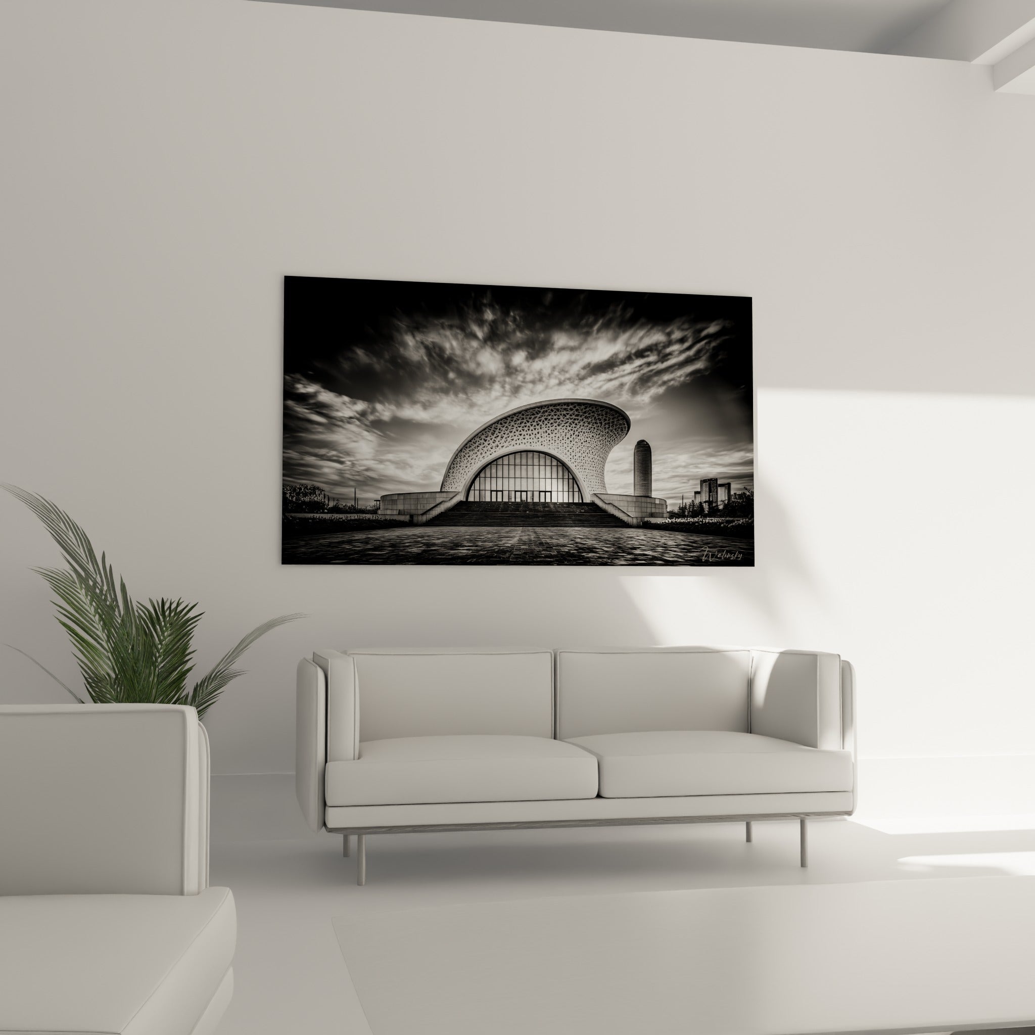 Bâtiment courbe anthracite et blanc au-dessus d'un canapé dans un salon lumineux et sobre