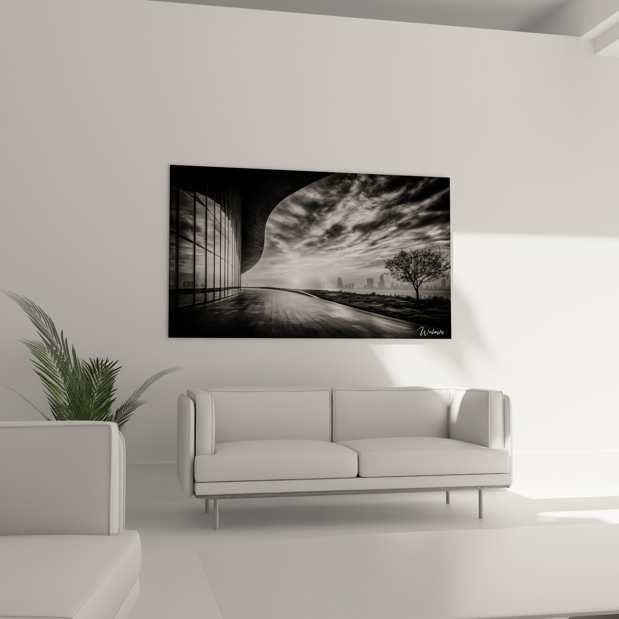 Façade vitrée aux reflets argentés et silhouette d'arbre noir sur ce tableau architecture abstrait, au-dessus d'un canapé dans un salon lumineux