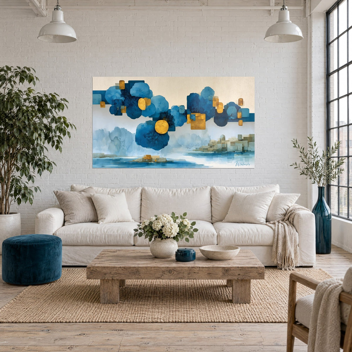 Wall art navy and gold geometric clouds floating on a cream background, above a sofa in a bright living room