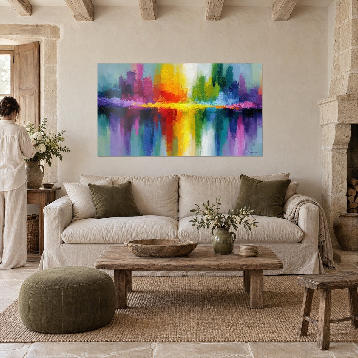 Tableau skyline abstrait aux tours violettes et jaunes reflétées dans l'eau, femme de dos, au-dessus d'un canapé dans un salon lumineux