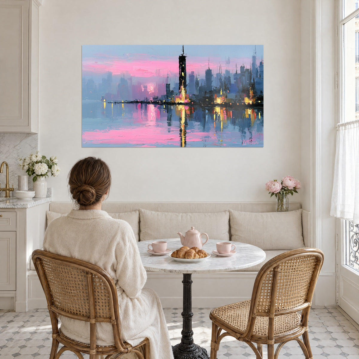 Wall art panorama of towers over water, pink sky and vibrant orange reflections, a woman seen from behind beside a round table in a living room