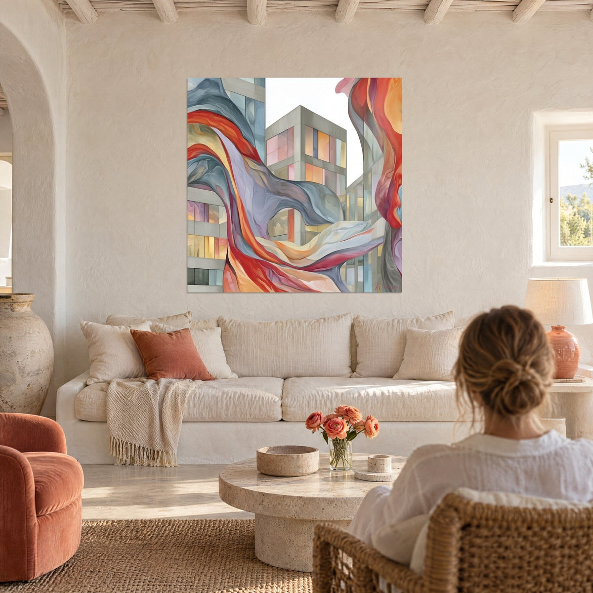Tableau immeubles gris traversés de rubans rouges ondulants, fenêtres rose et jaune, au-dessus d'un canapé dans un salon lumineux