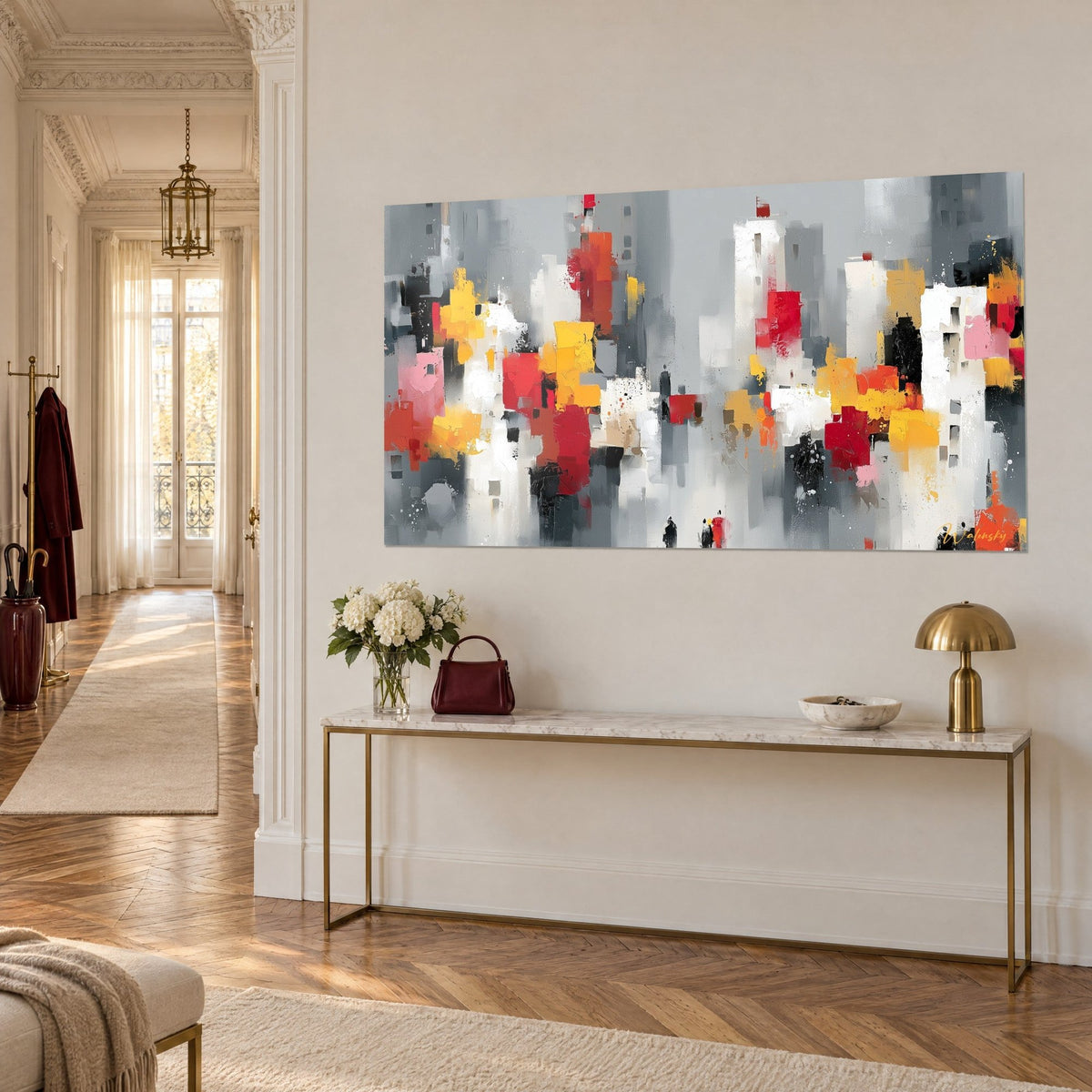 Tableau skyline abstraite de tours blanches et rouge vermillon aux touches ocre, vue de trois-quarts sur console dorée, appartement haussmannien