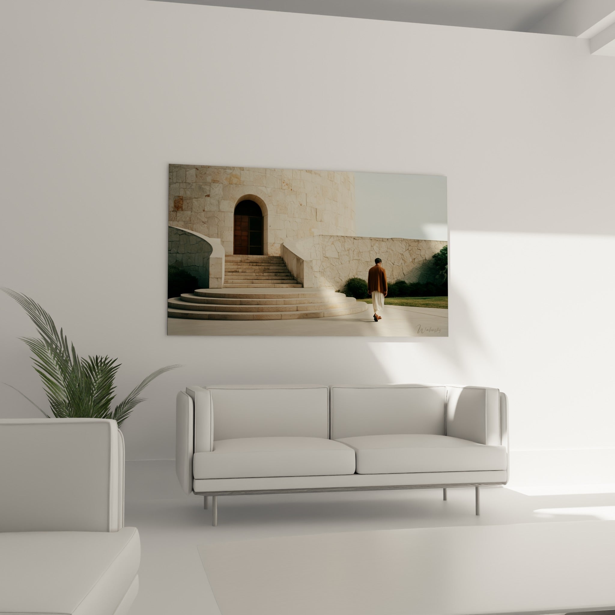 Bâtisse en pierre calcaire et personnage en manteau ocre, tableau architecture au-dessus d'un canapé dans un salon lumineux