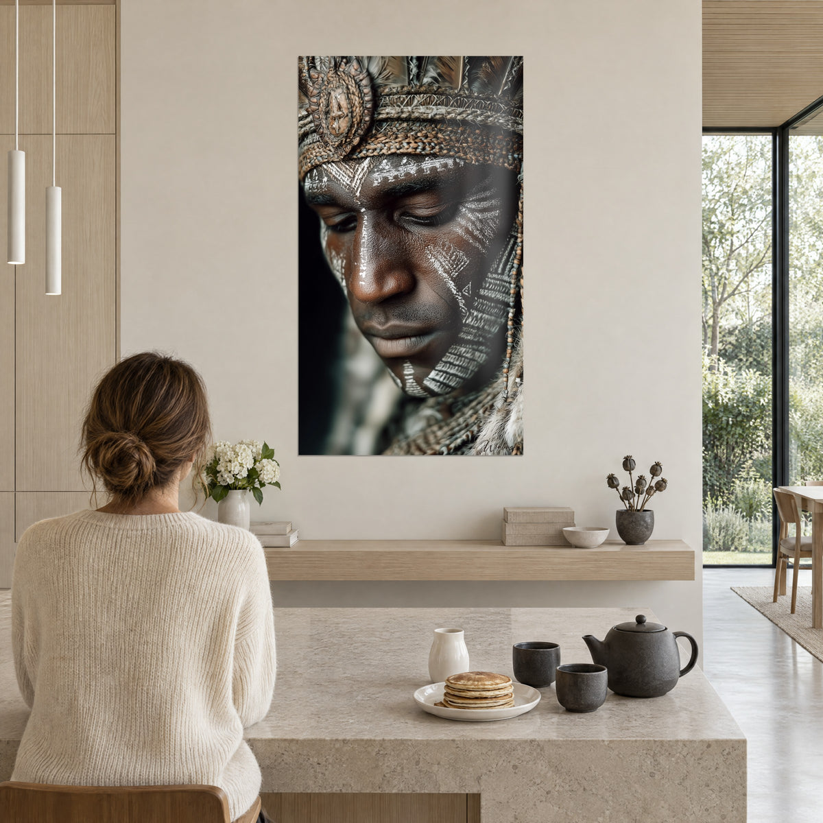 Wall art of a war mask carved with ivory lines, sand-colored braided fiber diadem, above a light wood kitchen