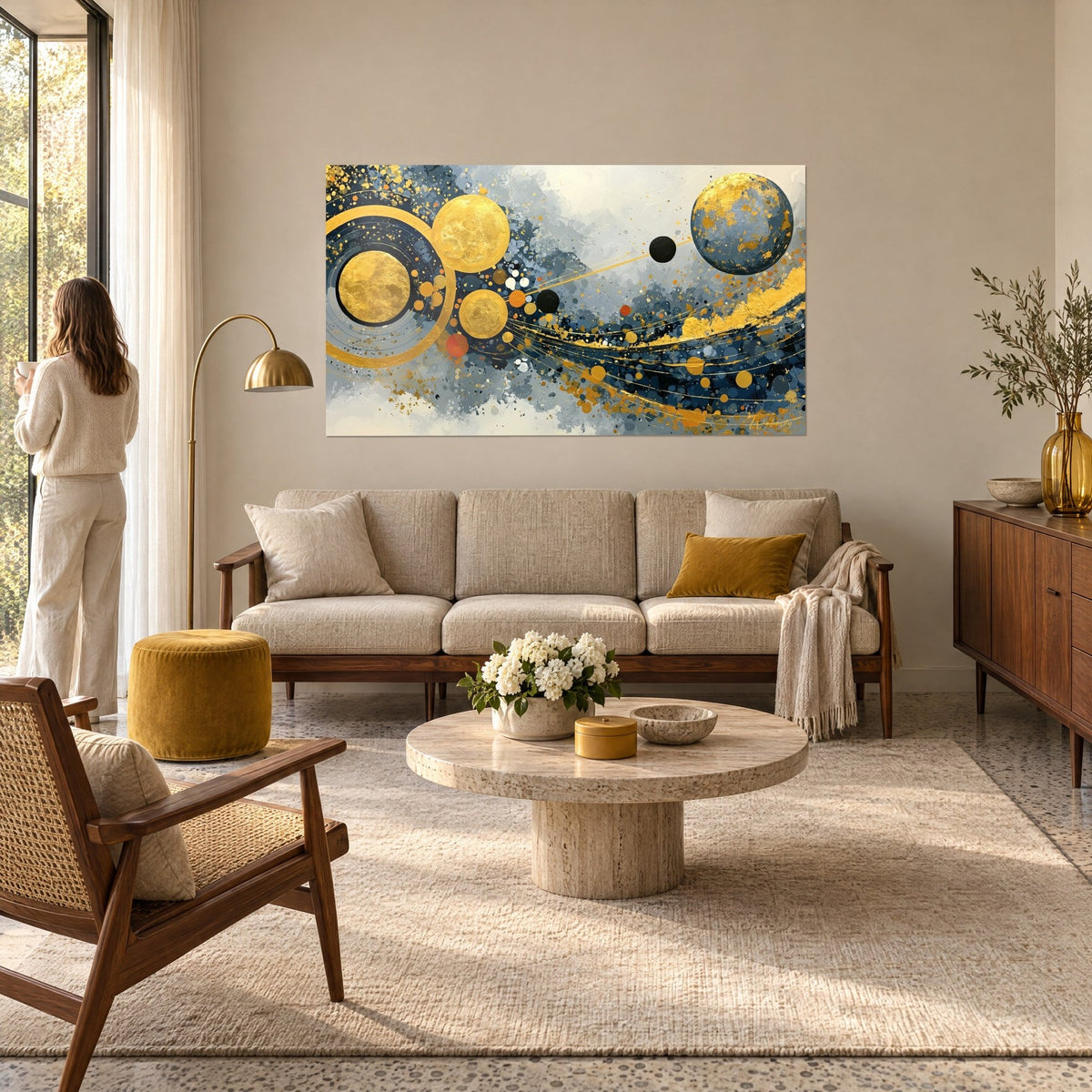 Cuadro planetas dorados y azul marino, círculos de pan de oro sobre fondo gris perla, encima de un sofá en un salón luminoso