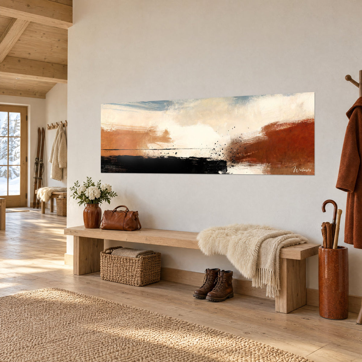 Tableau horizon abstrait aux touches orange et noires, ciel crème, accroché au-dessus d'un banc en bois dans l'entrée d'un chalet