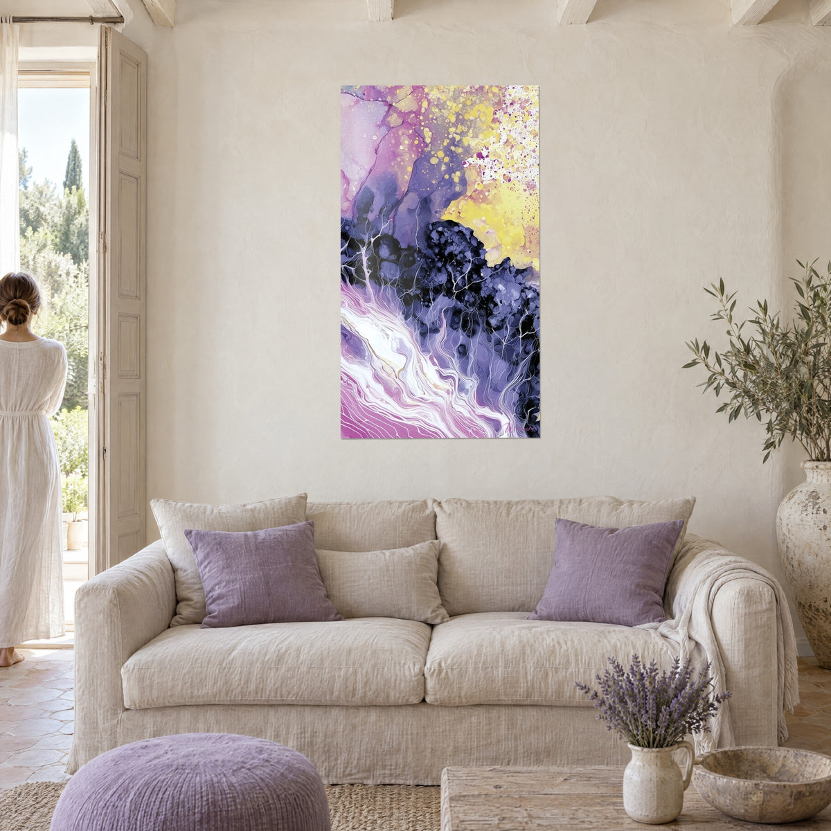 Wall art abstract with violet and sunny yellow streaks, white veins, a woman seen from behind, above a sofa in a bright living room