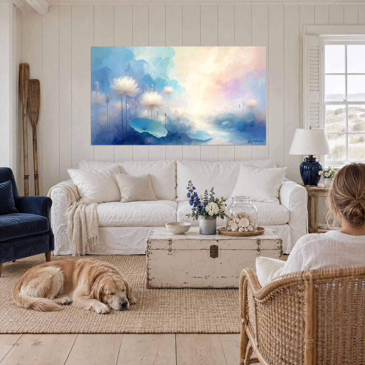 Schilderij van witte lotusbloemen die zweven in een nevel van vergeet-mij-nietblauw en roze, naast een retriever, boven een bank in een lichte woonkamer