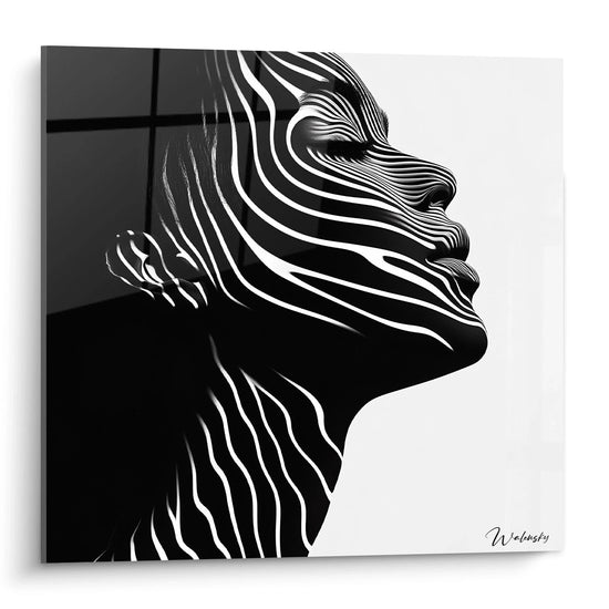 Un tableau rayures noir et blanc présentant un profil humain stylisé composé de lignes ondulées parallèles. Le contraste prononcé entre les zones noires et blanches crée une illusion de volume et de mouvement, avec des textures lisses et des effets de relief optique.
