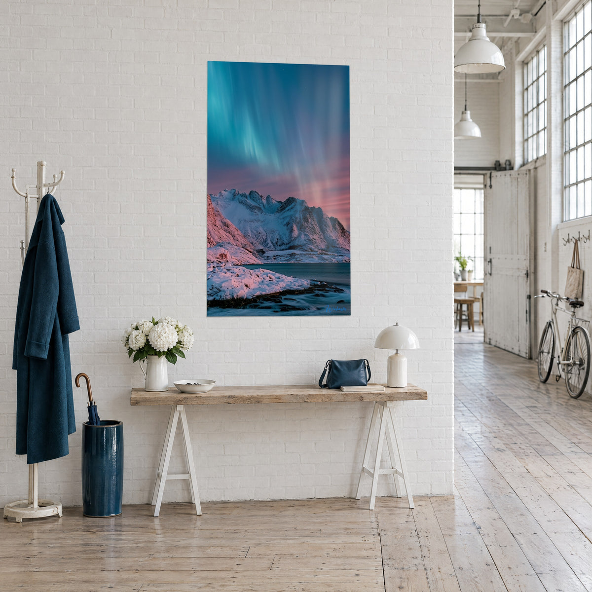 Wall art rocky ridge dusted with pink snow under a turquoise sky, hung above a wooden console, loft