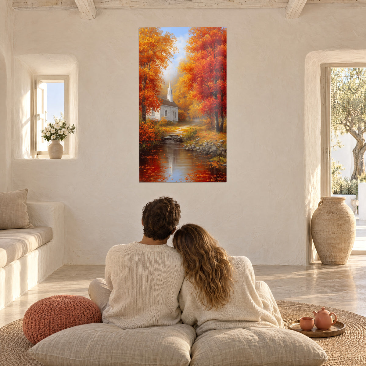 Wall art white church on a stream bank, red and golden maples, couple seen from behind tenderly embracing on cushions, sunlit vaulted living room