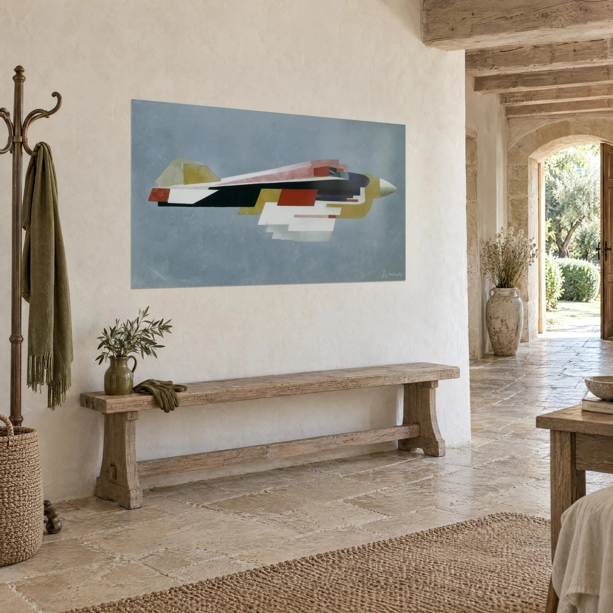 Wall art futuristic jet in flat white and black planes, pointed ivory nose, hung on a stone wall beside a bench, country house
