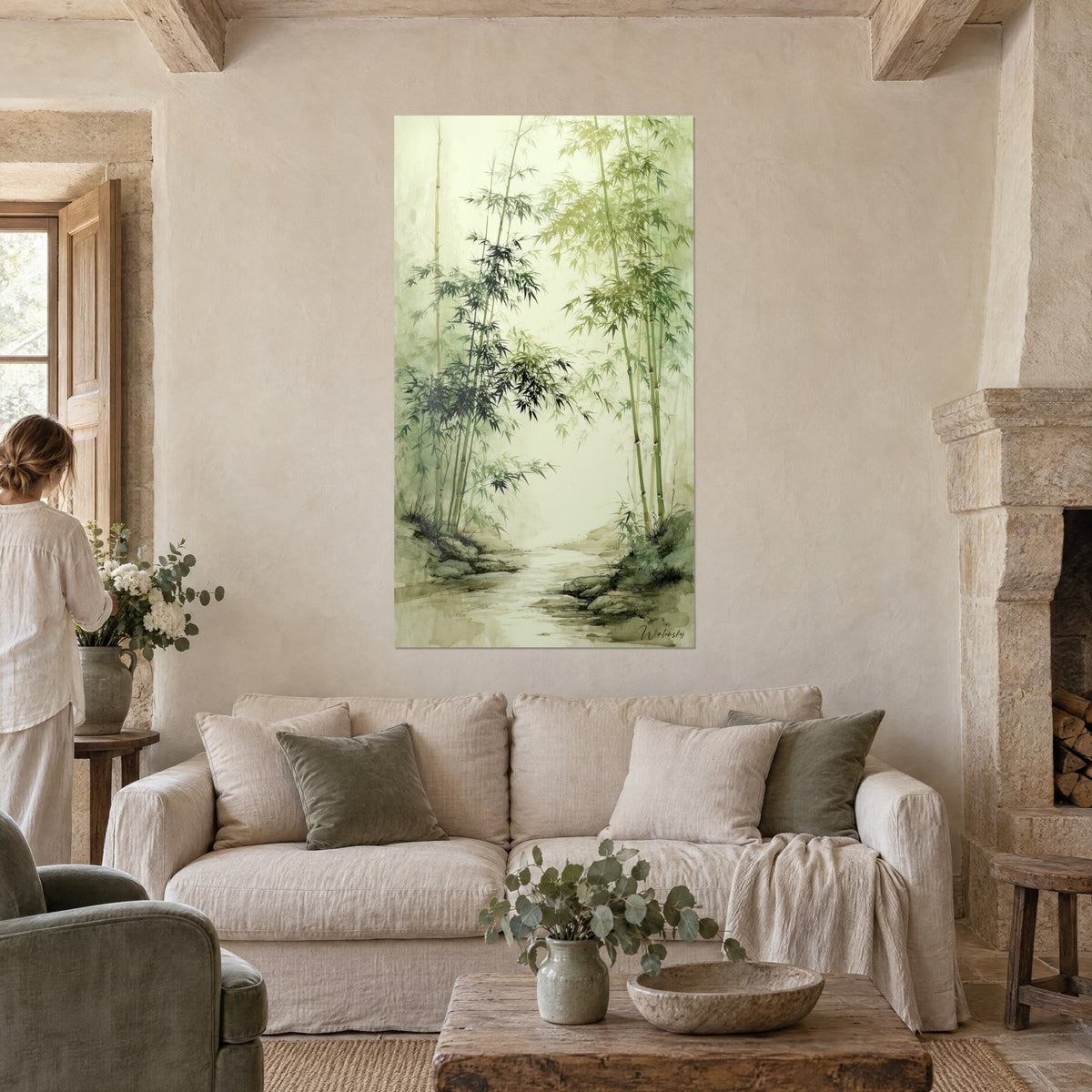 Wall art bamboo in soft green and olive ink wash, black ink-like foliage, misty stream, a woman seen from behind, above a sofa in a bright living room