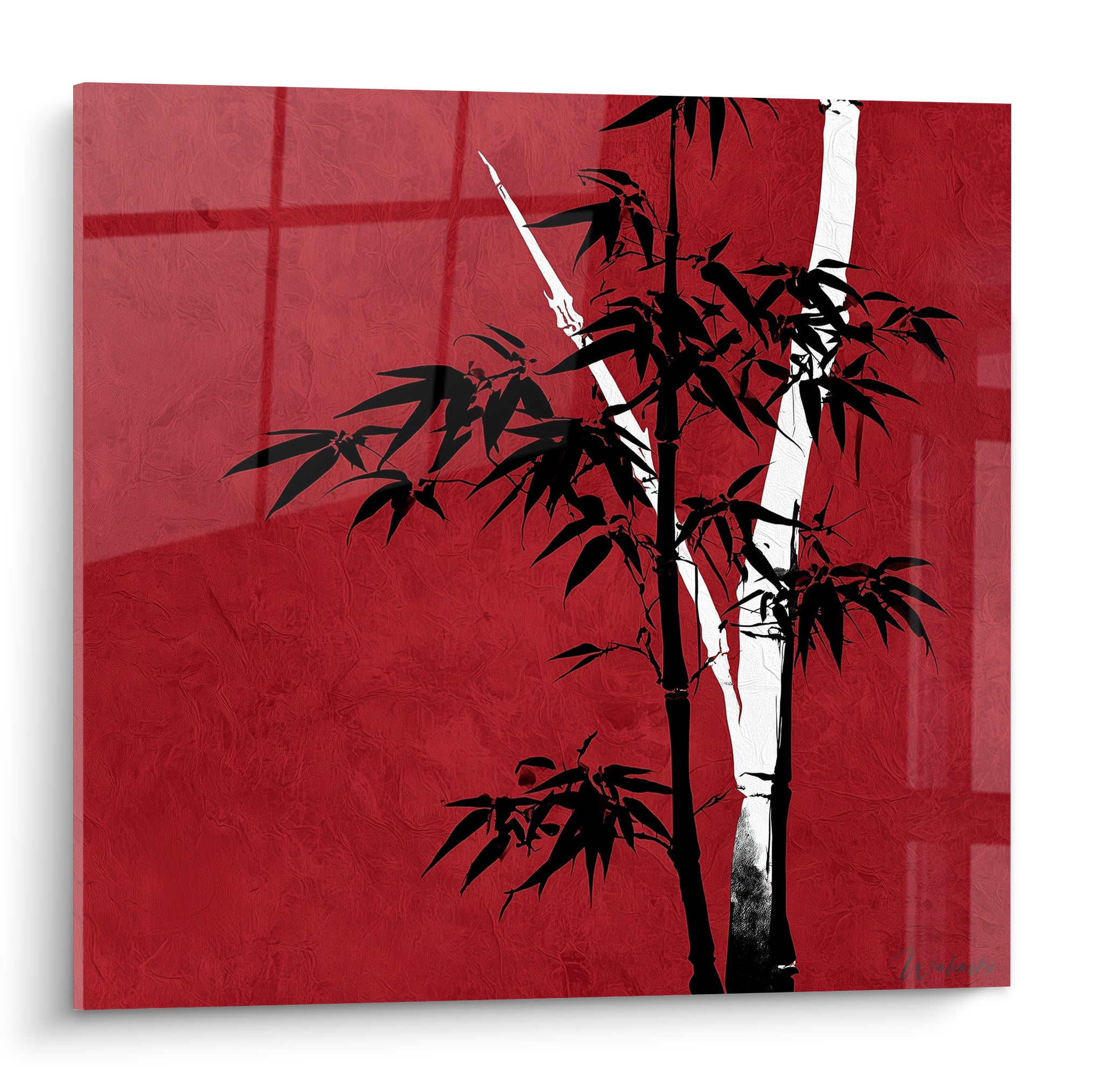 Bambou noir et blanc dressé sur fond rouge intense, silhouette graphique aux feuilles pointues