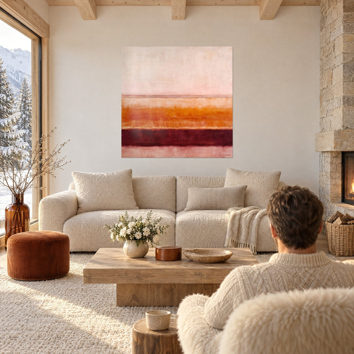 Wall art abstract horizontal stripes in pale pink, burnt orange and burgundy, two people seen from behind above a sofa in a bright living room