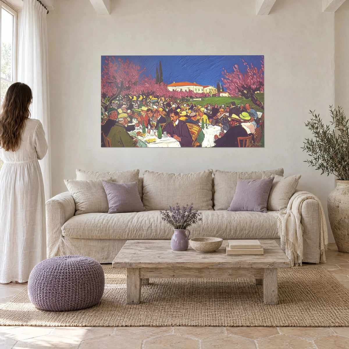 Wall art banquet beneath blooming pink trees, tables of guests in yellow hats, blue sky, above a sofa in a bright living room