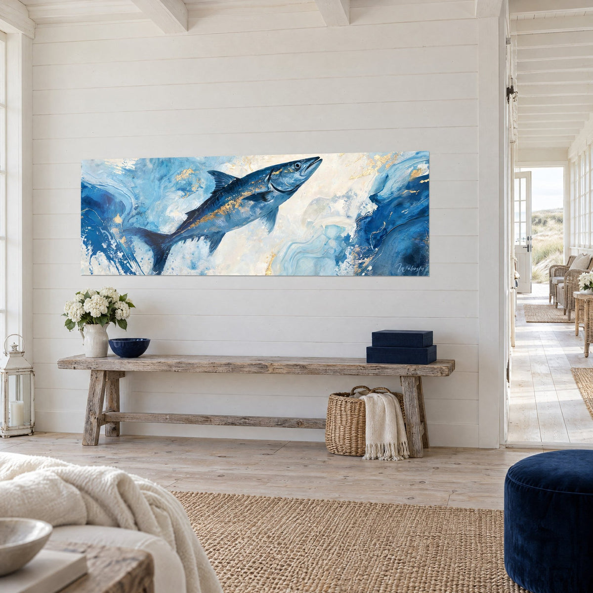 Wall art predatory fish slicing through the waves, midnight-blue fins with gold accents, on a white wall beside a wooden console