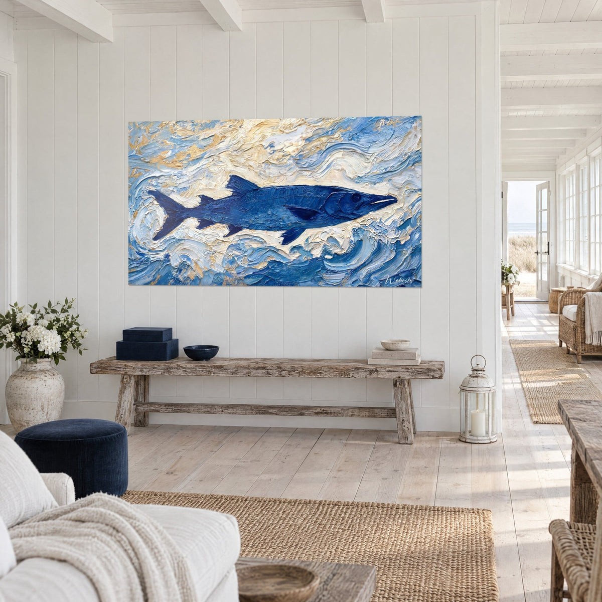 Wall art of an indigo needlefish with upright fins on a cream and gold foam background, seen at three-quarter view in a seaside home