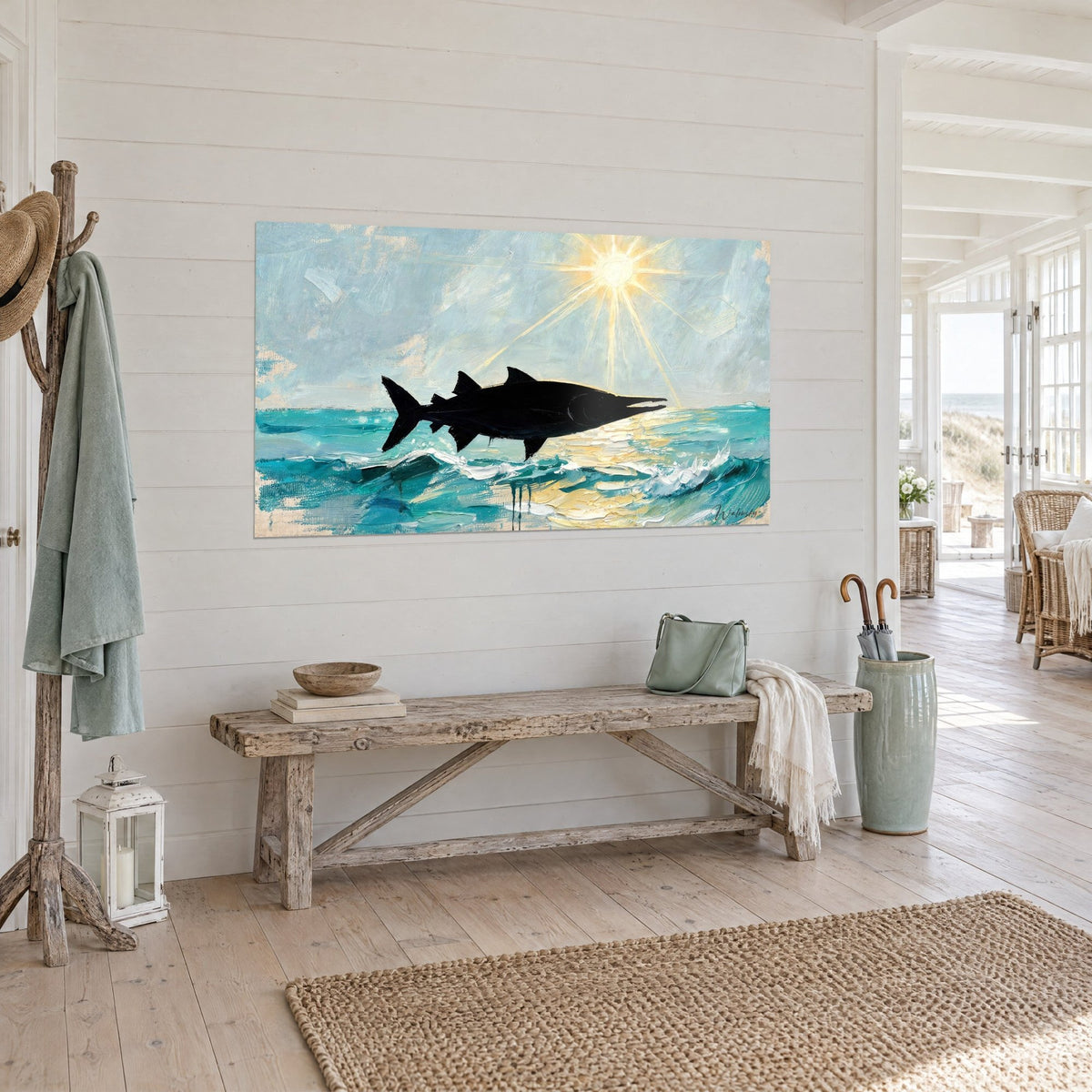 Wall art black ink silhouette of a barracuda springing from a blue-green sea, cream light rays on a white wooden wall by the seaside