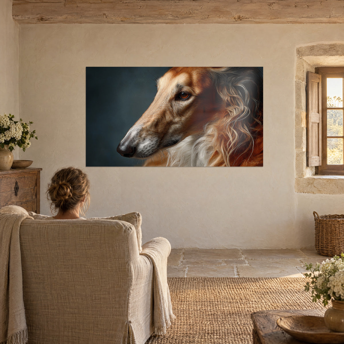 Wall art of a pensive borzoi with russet and white fur, ember-like eye, viewed from a beige armchair in a stone-walled room