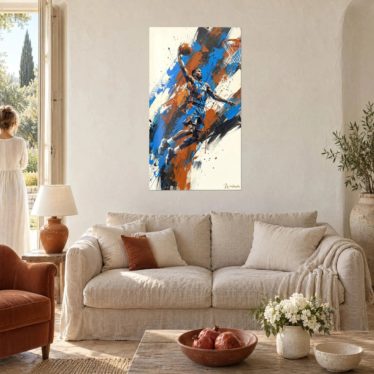 Wall art of a basketball player mid-dunk, cobalt blue jersey and rust orange splashes, above a sofa in a bright living room
