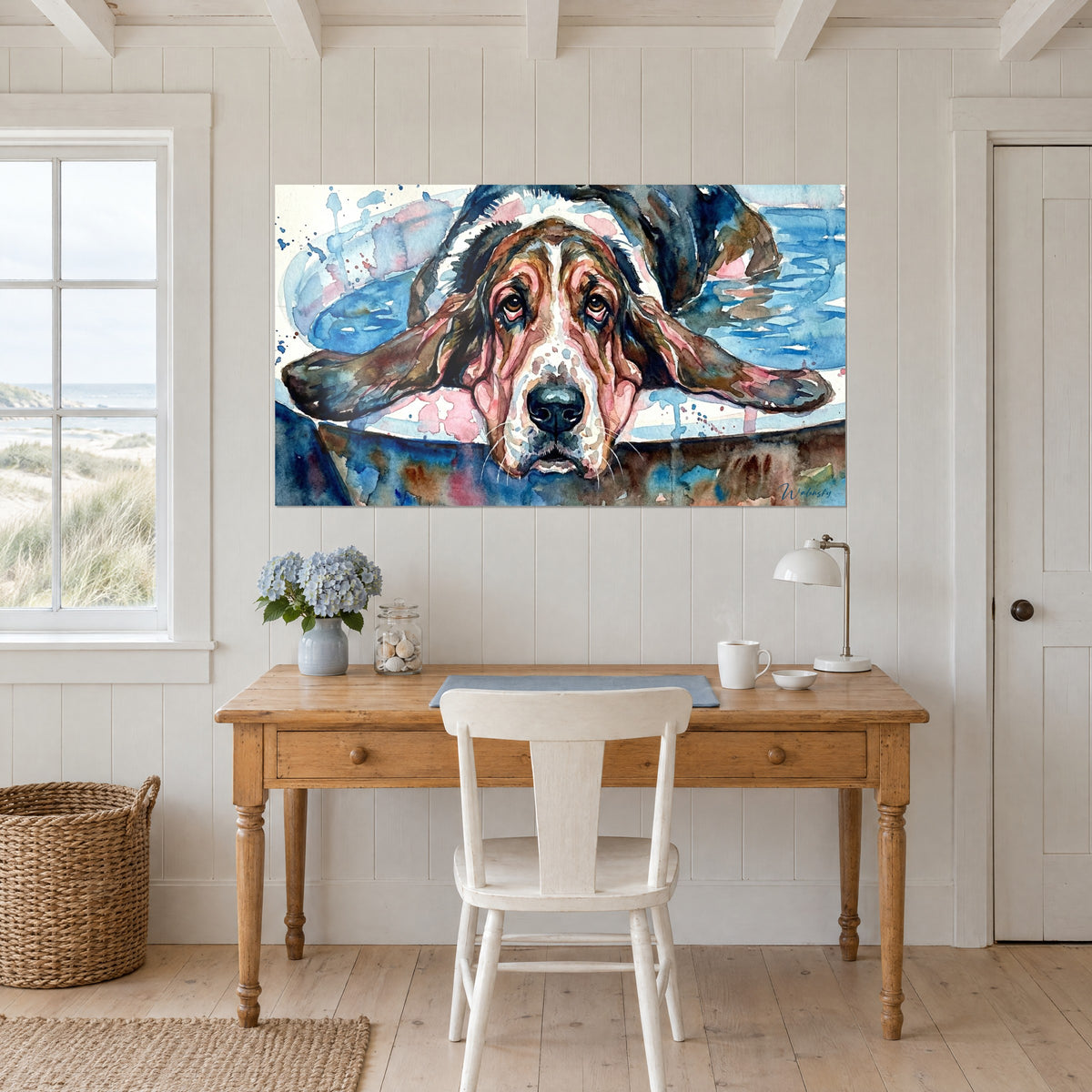 Cuadro de una cabeza de basset hound en reposo, nariz negra brillante y bigotes blancos, fondo turquesa y rosa, sobre un escritorio de madera