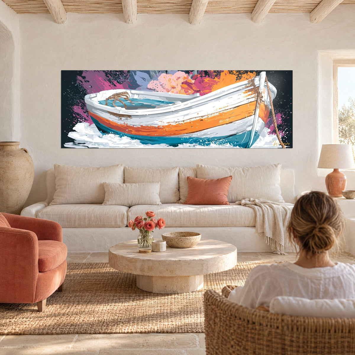 Wall art White boat with orange and turquoise hull against pink splashes, woman seen from behind above a sofa in a bright living room