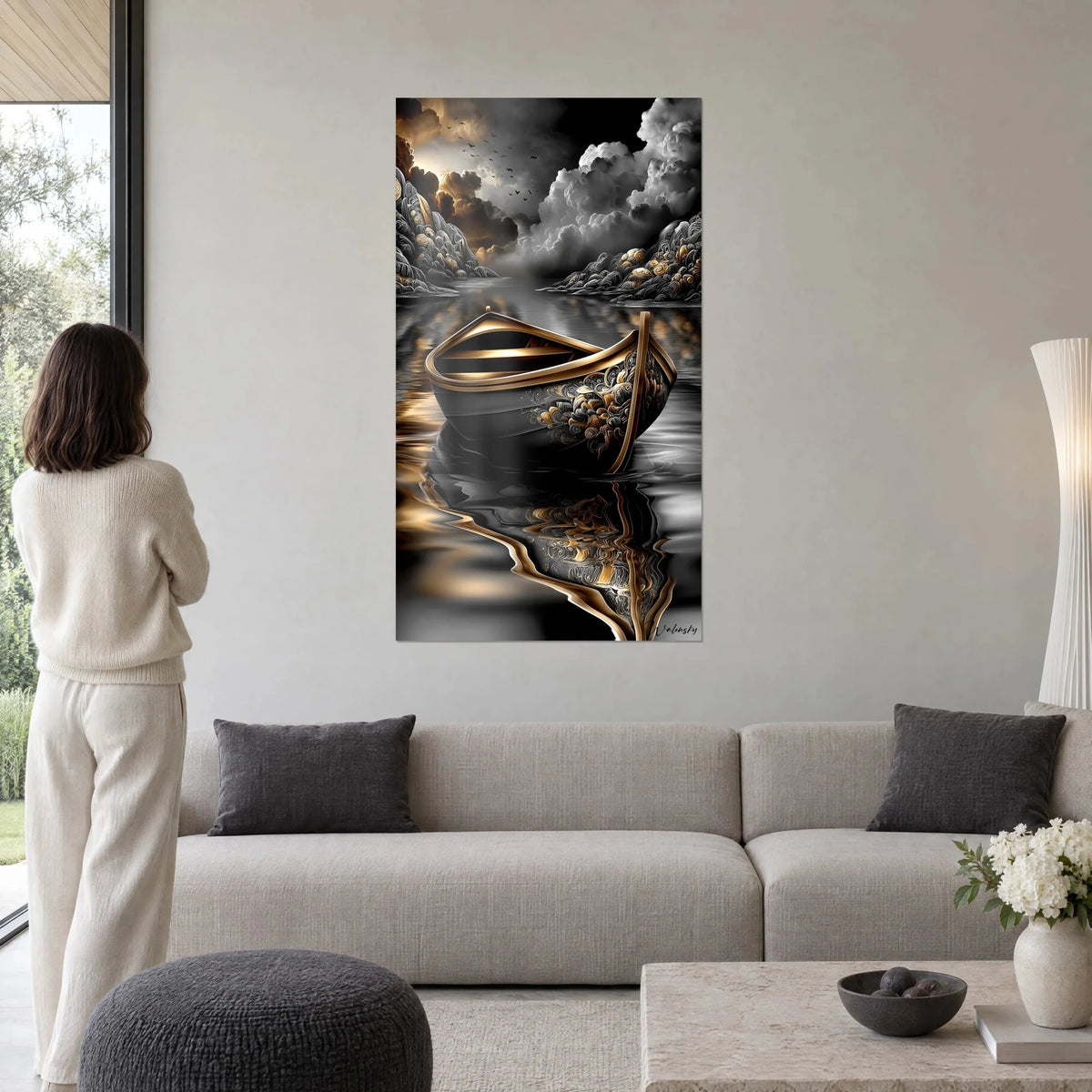 Wall art ornate golden boat floating on black water, grey clouds and copper reflections, above a sofa in a bright living room