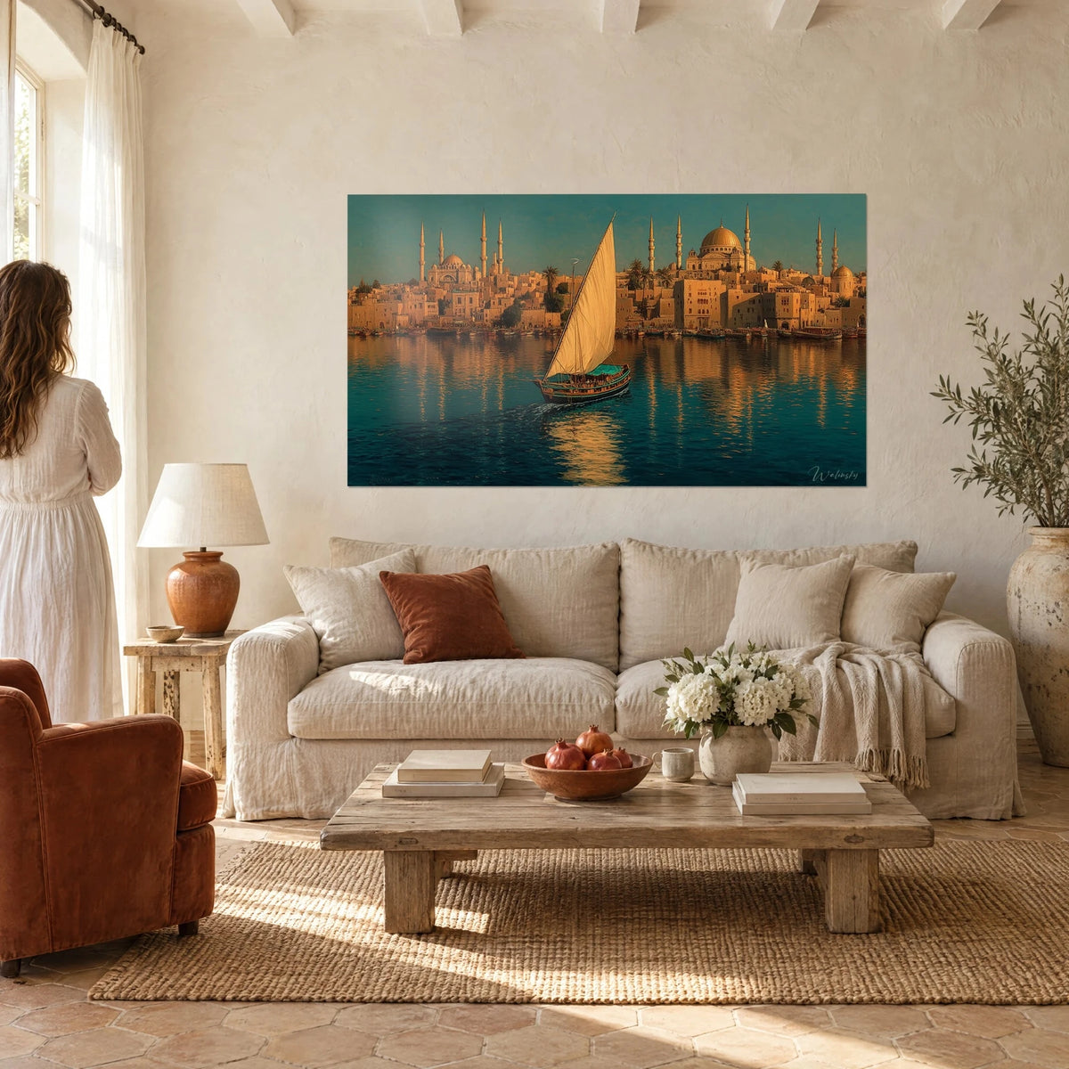 Wall art felucca with ivory sail gliding over turquoise water in front of golden minarets, above a sofa in a bright living room
