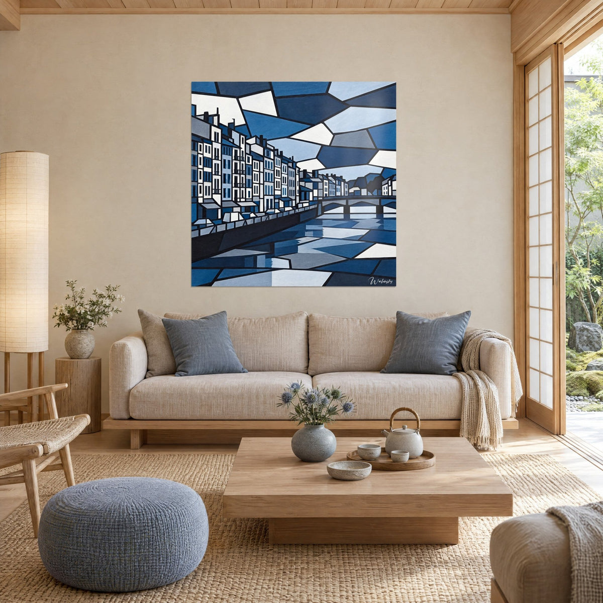 Tableau façades d'immeubles blanches en mosaïque bleu marine et gris sur un quai, accroché au-dessus d'un canapé dans un salon lumineux