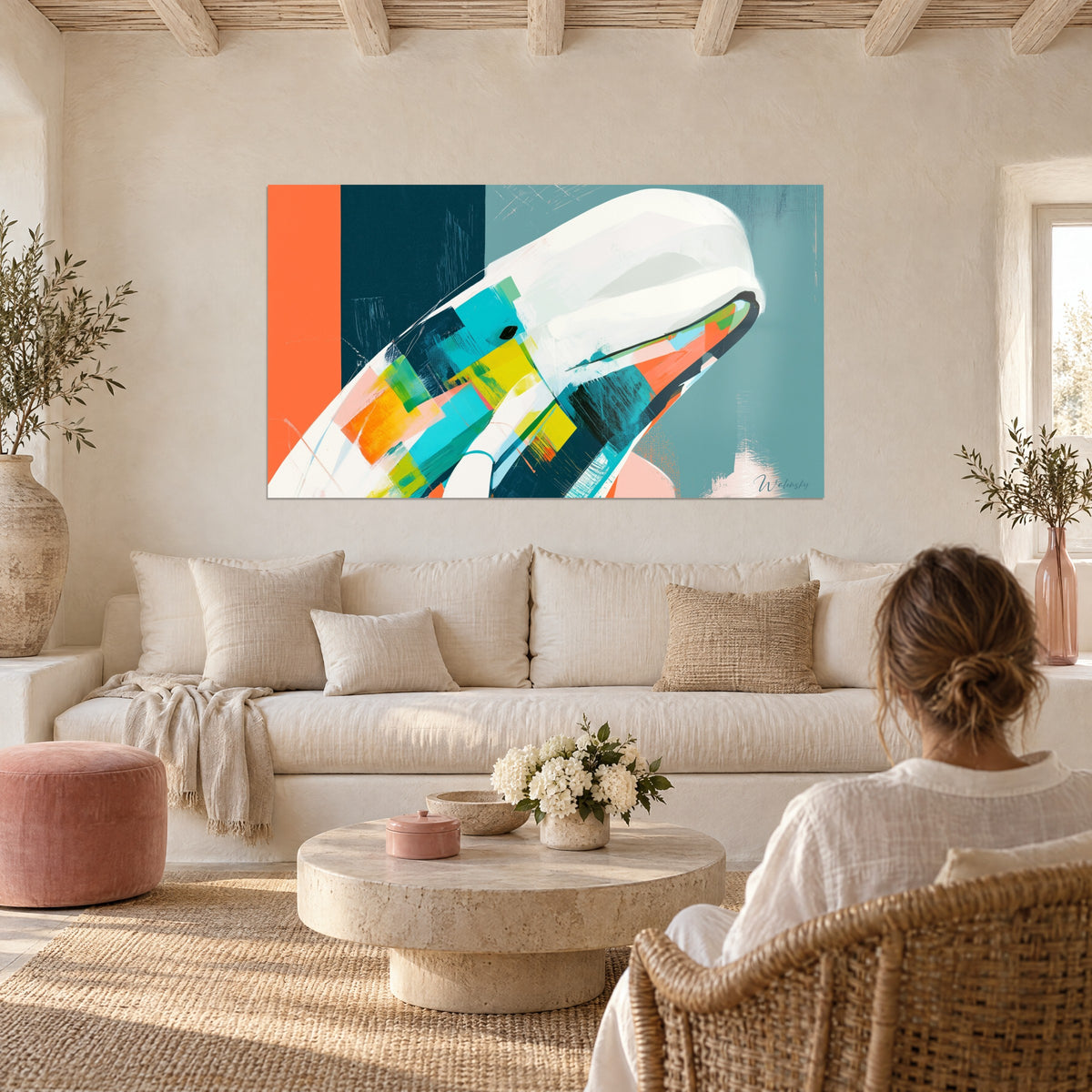 Wall art White cream beluga with turquoise and coral accents, hung above a sofa in a bright living room