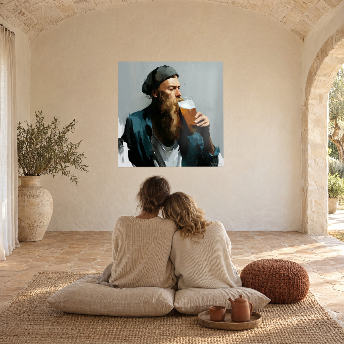 Wall art of a bearded figure in a black beanie toasting with themselves, golden beer, grey background, salon with pale stone walls, a couple seated from behind
