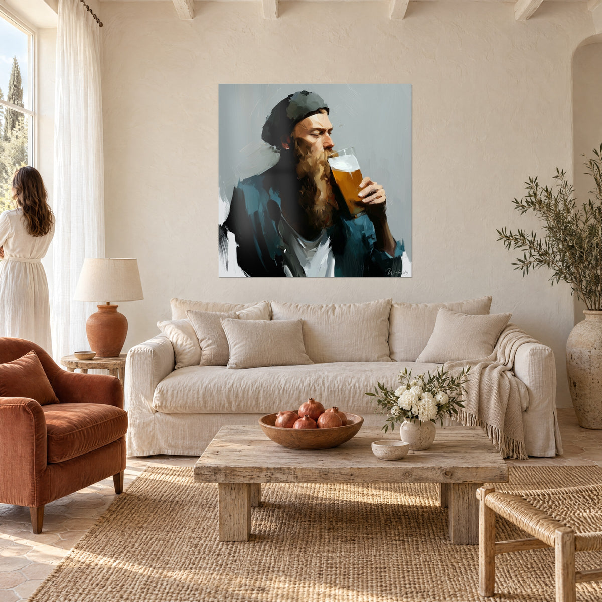 Wall art of a bearded beer drinker with tawny beard raising his amber pint, petrol-blue jacket against a grey background, above a sofa in a bright living room