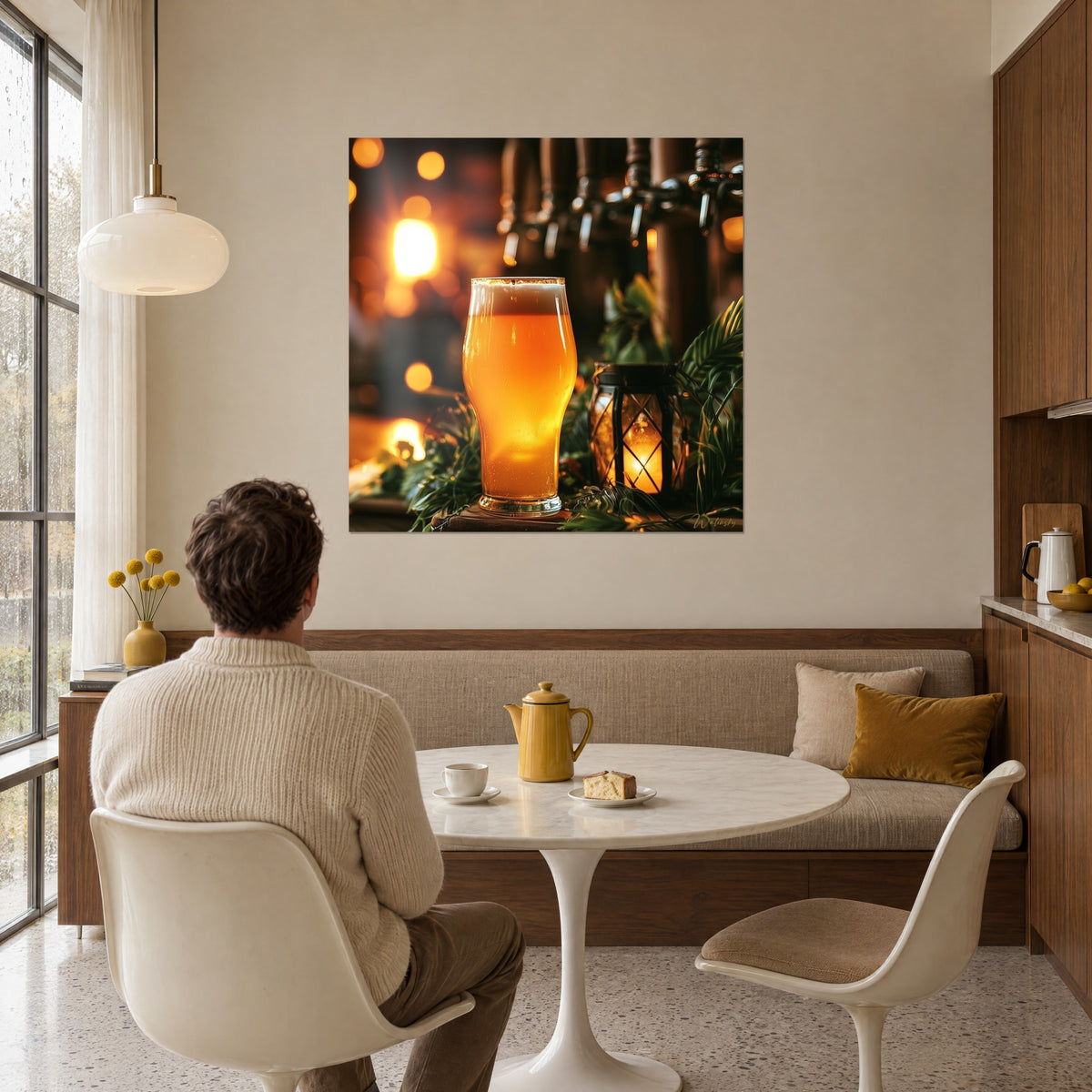 Cuadro vaso de cerveza con espuma junto a un farol romboidal, destellos ocres y ramas verdes, sobre una pared beige de comedor