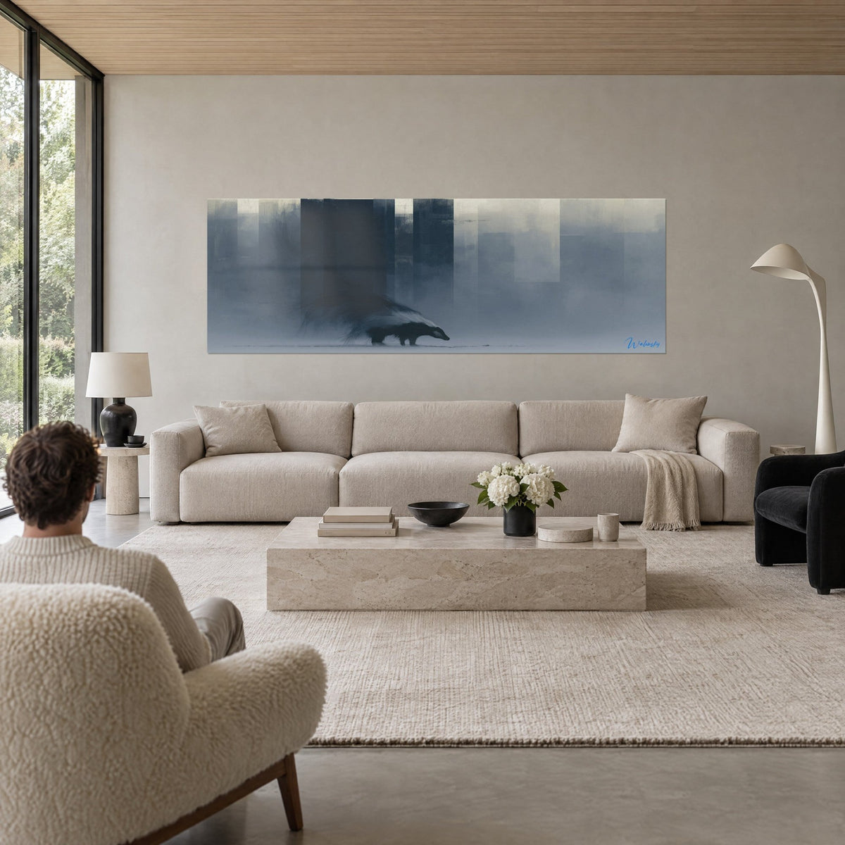 Wall art striped badger advancing through slate blue and pearl grey mist, blurred towers, above a sofa in a bright living room
