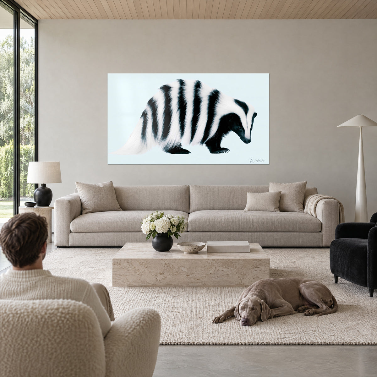 Schilderij das met zwarte strepen op ivoorkleurige vacht, ijsblauwe achtergrond, boven een bank in een lichte woonkamer