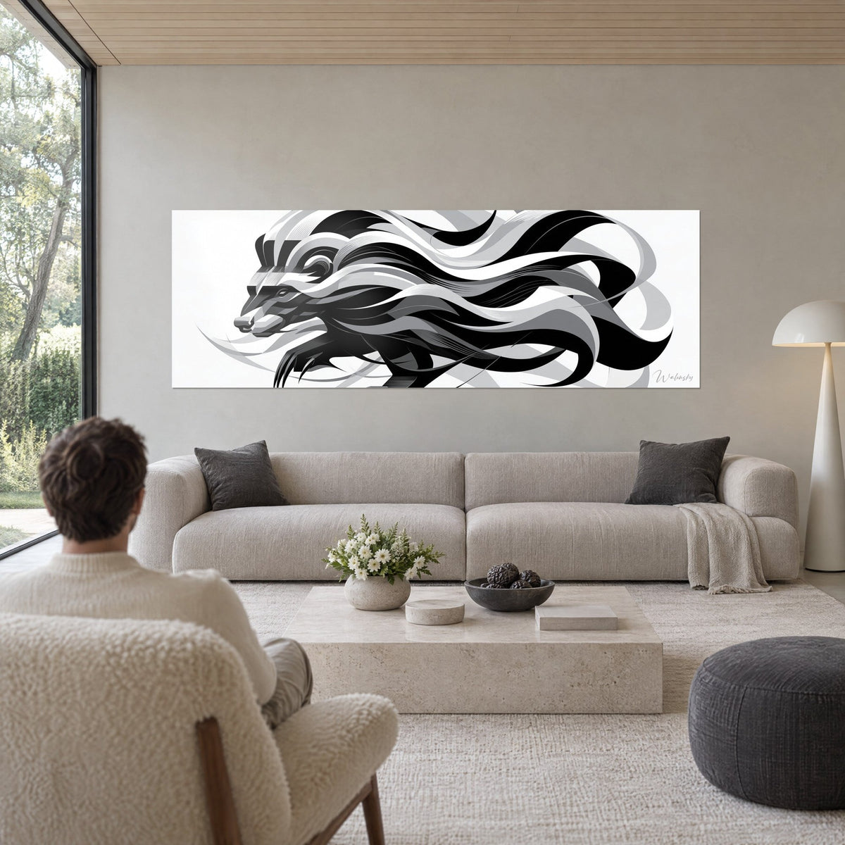 Tableau blaireau stylisé en rubans noirs et gris, museau pointé à gauche, fond blanc, au-dessus d'un canapé dans un salon lumineux