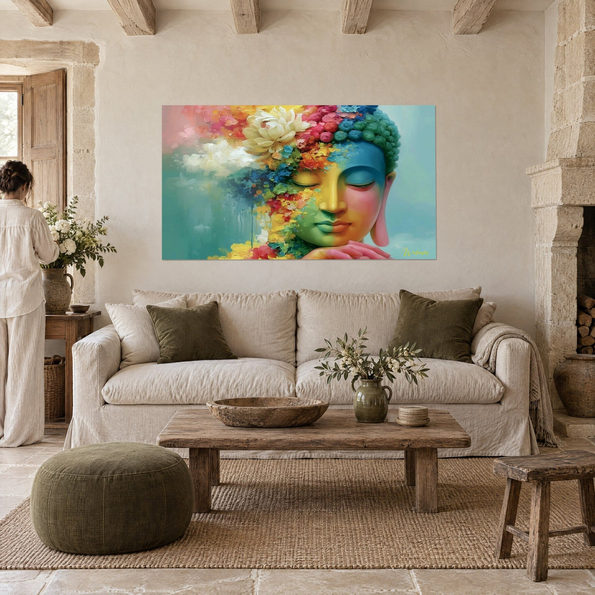 Wall art Buddha with closed eyelids, yellow and blue face beneath pink peonies, hanging above a sofa in a bright living room