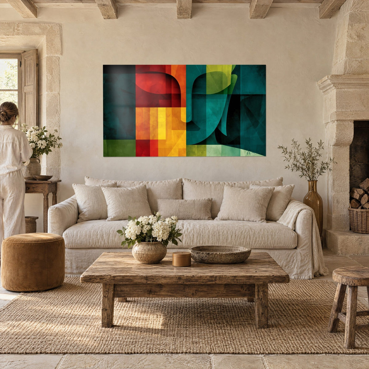 Tableau visage de Bouddha en aplats sarcelle et rouge, vitrail géométrique, au-dessus d'un canapé dans un salon lumineux