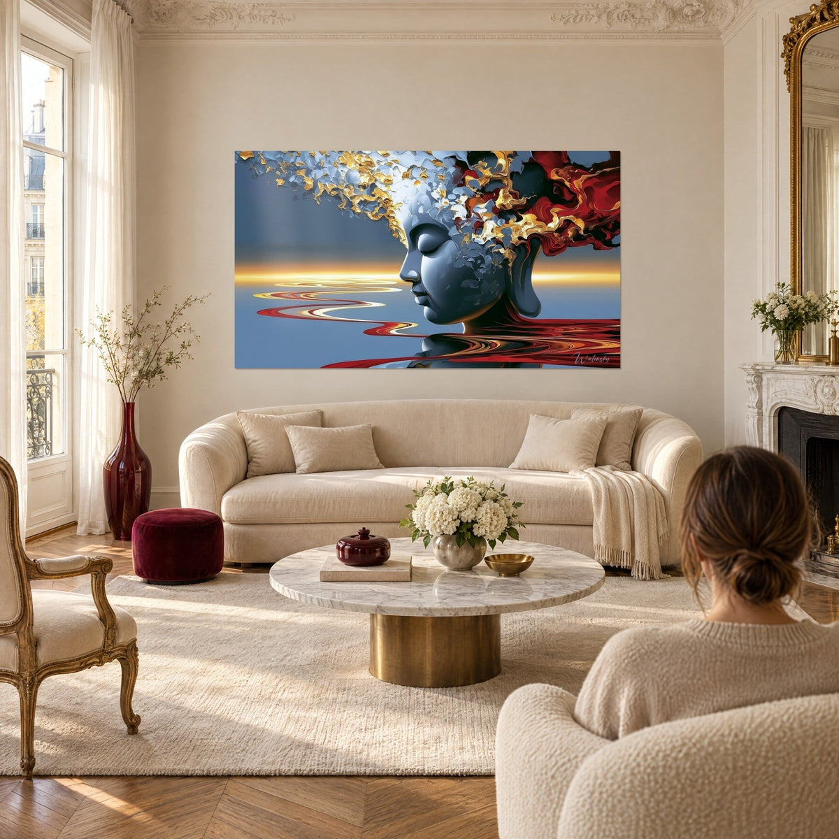 Tableau profil de Bouddha gris-bleu, éclats d'or et de rouge dans les cheveux, au-dessus d'un canapé dans un salon lumineux