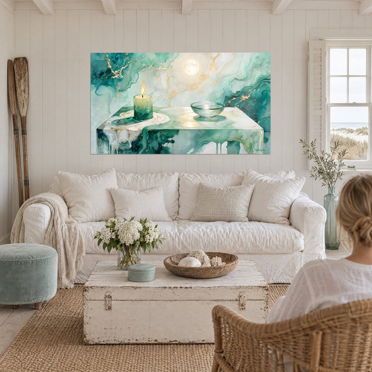 Wall art with a golden candle flame beside a glass bowl, emerald table with gold marble veining, hung above a sofa in a bright living room