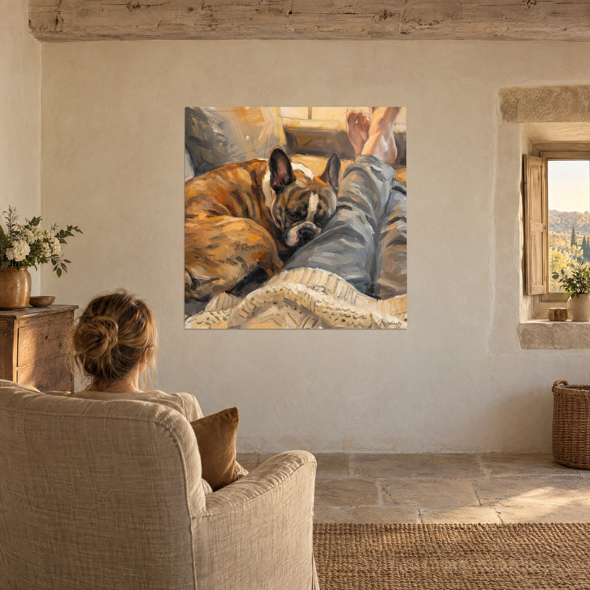 Quadro di un cucciolo addormentato stretto al suo padrone, fianchi ramati, pantaloni grigio-azzurro, plaid avorio, poltrona in lino, muro di pietra