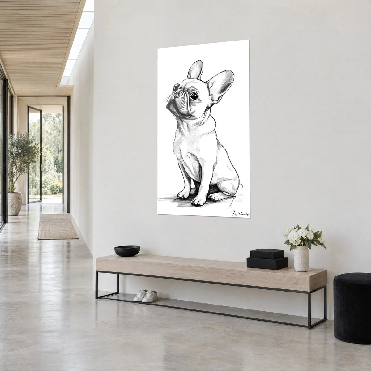 Wall art dog with large ears, black line sketch on white background, beige console and white flowers, bright hallway