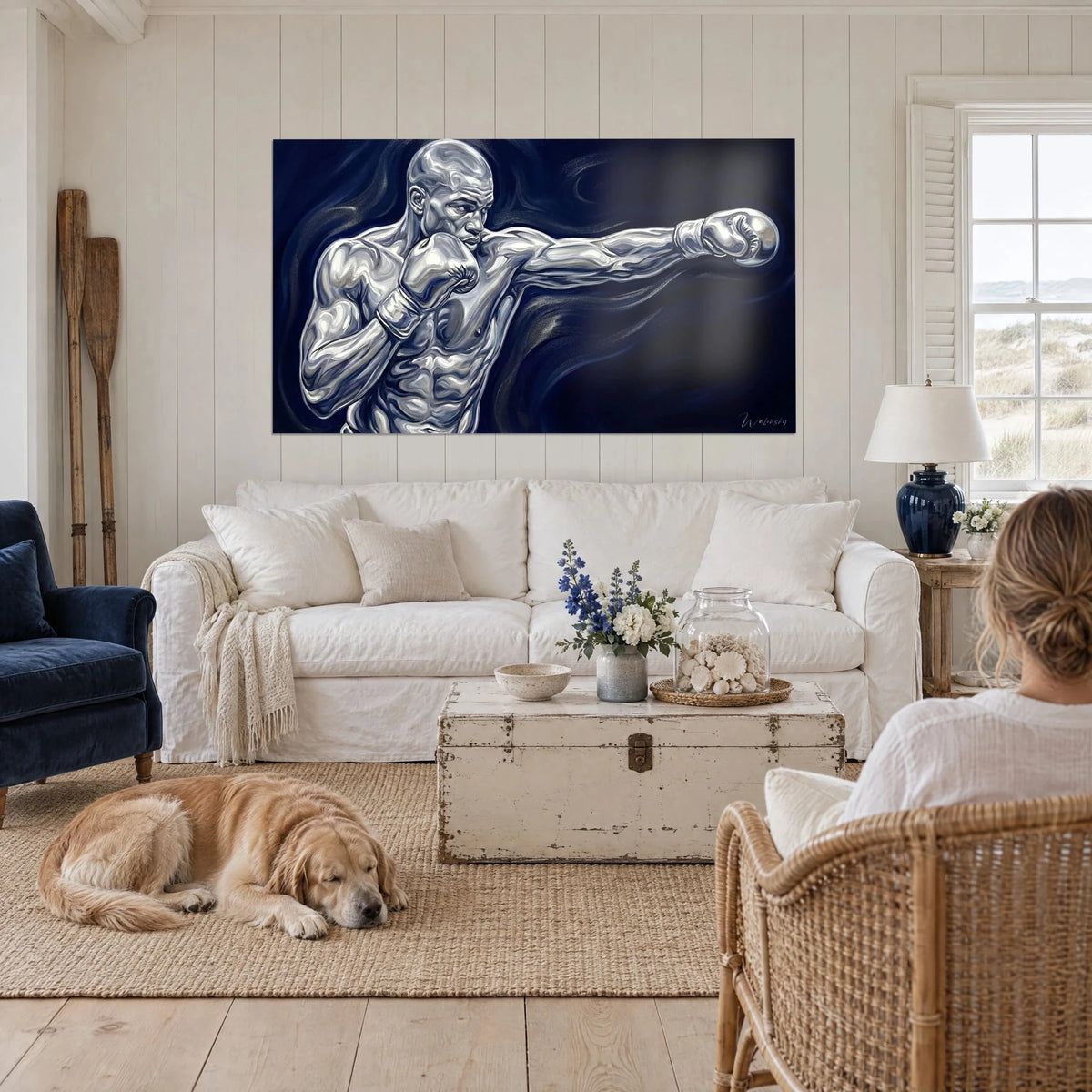 Wall art chrome boxer mid right hook, deep midnight blue swirling background, a woman and a blonde dog above a sofa in a bright living room