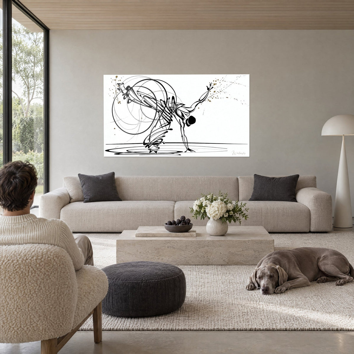 Gemälde Breakdance-Tänzer in schwarzen Tuschestrichen, goldene Spritzer auf weißem Grund, über einem Sofa in einem hellen Wohnzimmer