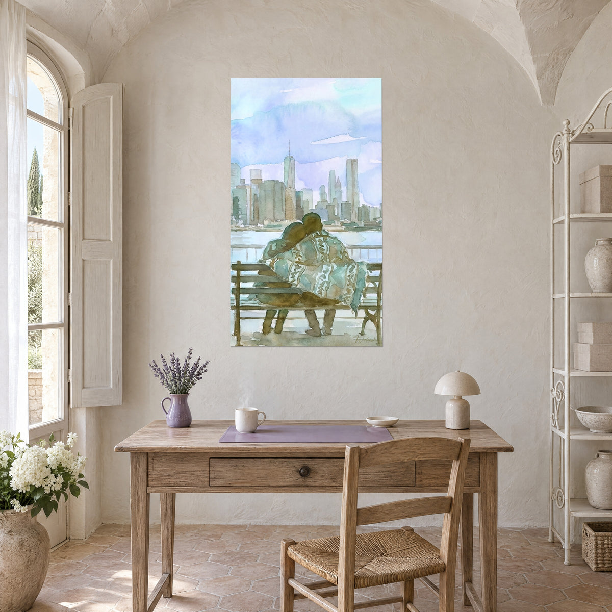 Wall art of the New York skyline in watercolor with a pair on a wooden bench, pastel blues and sage greens, hung above a light wood desk
